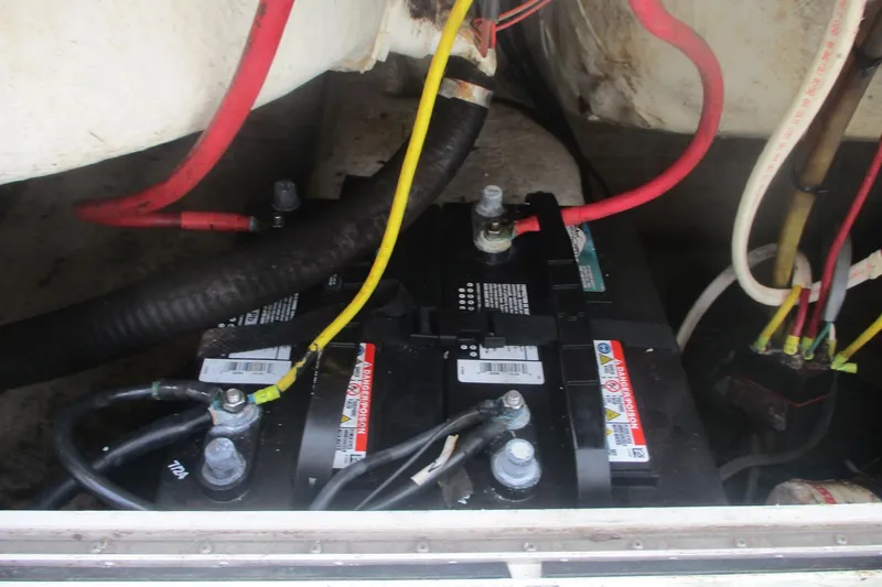 Slide: The Image of Battery compartment of a 2005 Sailfish 236 CC boat with visible wiring. - 13