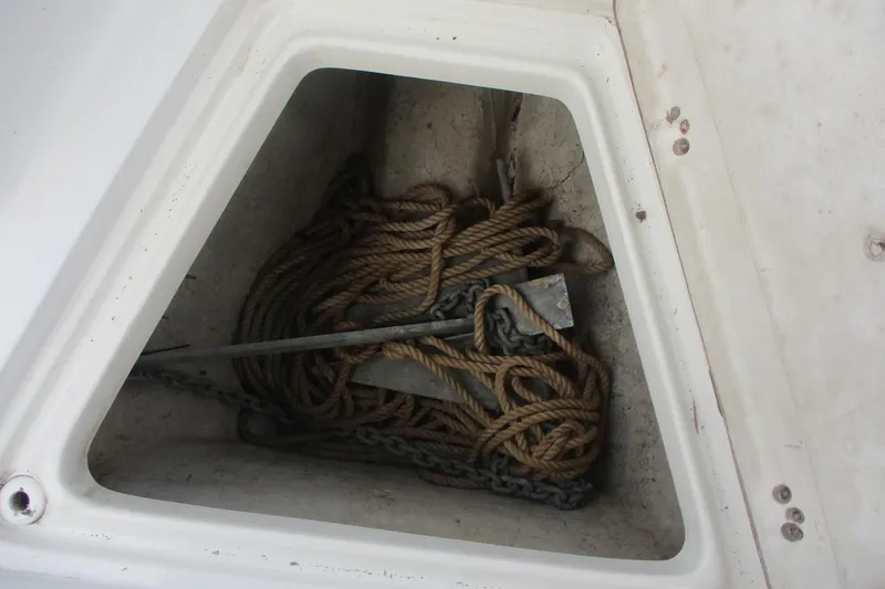 Slide: The Image of Anchor and rope storage in 2005 Sailfish 236 CC boat compartment. - 15