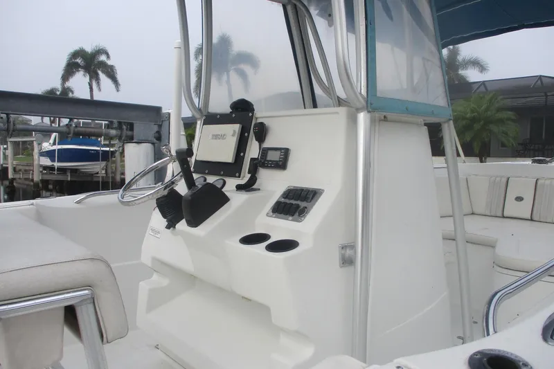 Slide: The Image of 2005 Sailfish 236 CC boat interior with steering console and seating area. - 3