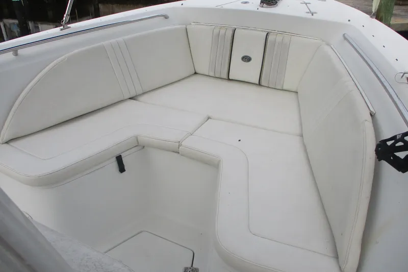 Slide: The Image of 2005 Sailfish 236 CC boat interior with white cushioned seating. - 6
