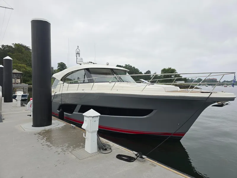 The Image of 2022 Riviera 505 SUV yacht docked at marina on a cloudy day. - 0