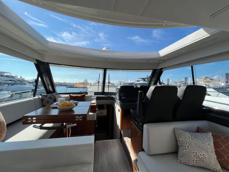 Slide: The Image of Luxurious interior of 2022 Riviera 505 SUV yacht with panoramic windows and elegant seating. - 28