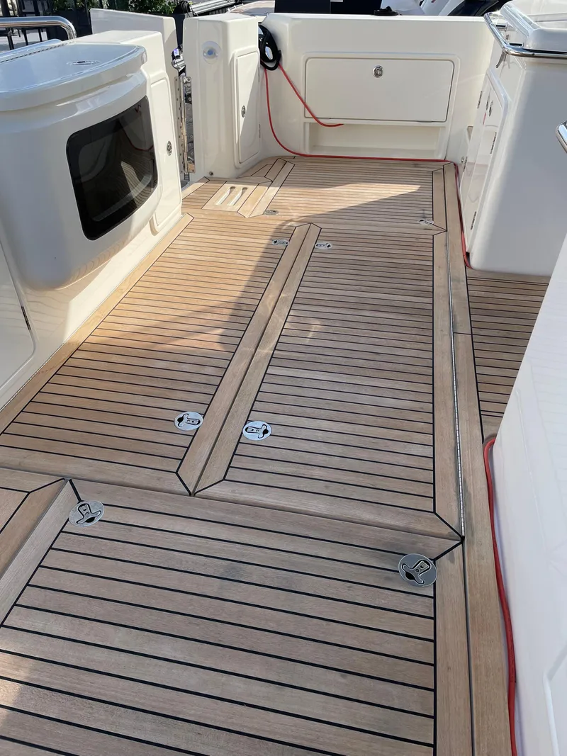 Slide: The Image of Teak deck of 2022 Riviera 505 SUV yacht, featuring sleek design and modern amenities. - 49