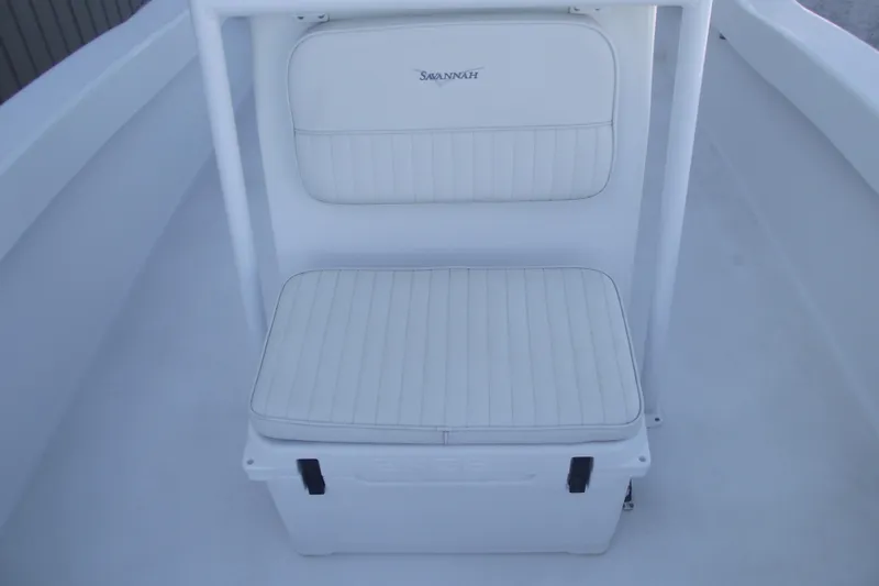 Slide: The Image of White cushioned seat on 2021 Savannah SS21 boat, featuring sleek design and storage. - 12