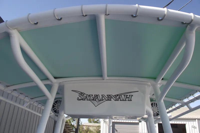 Slide: The Image of 2021 Savannah SS21 boat canopy with logo, featuring light blue and white design. - 13
