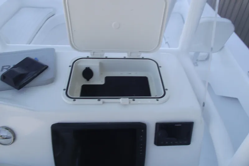 Slide: The Image of 2021 Savannah SS21 boat console with open storage compartment and electronic controls. - 22