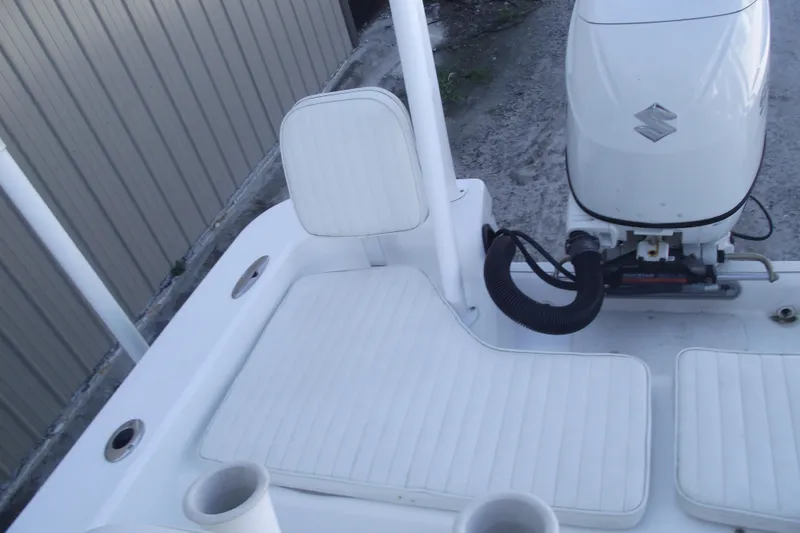 Slide: The Image of 2021 Savannah SS21 boat with Suzuki outboard motor and white seating. - 26