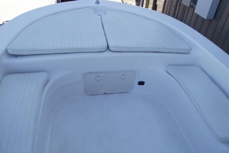 Slide: The Image of 2021 Savannah SS21 boat interior with white cushioned seating and storage compartment. - 5