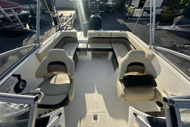 Slide: The Image of 2020 Hurricane SunDeck 217 OB boat interior with seating and steering wheel. - 10