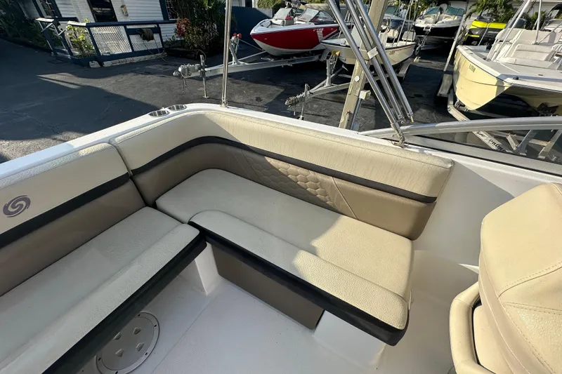 Slide: The Image of 2020 Hurricane SunDeck 217 OB boat interior with beige seating and cup holders. - 12
