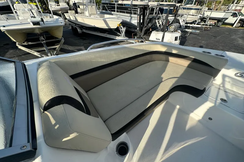 Slide: The Image of 2020 Hurricane SunDeck 217 OB boat interior with cushioned seating and cup holders. - 16