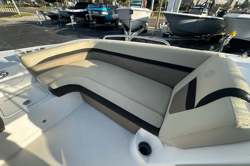 Slide: The Image of 2020 Hurricane SunDeck 217 OB boat interior with beige seating and cup holders. - 17