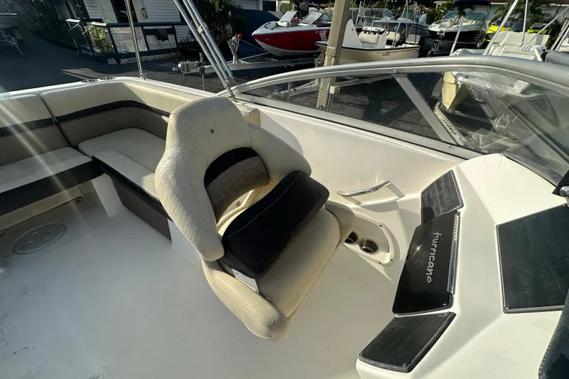 Slide: The Image of 2020 Hurricane SunDeck 217 OB boat interior with seating and steering console. - 19