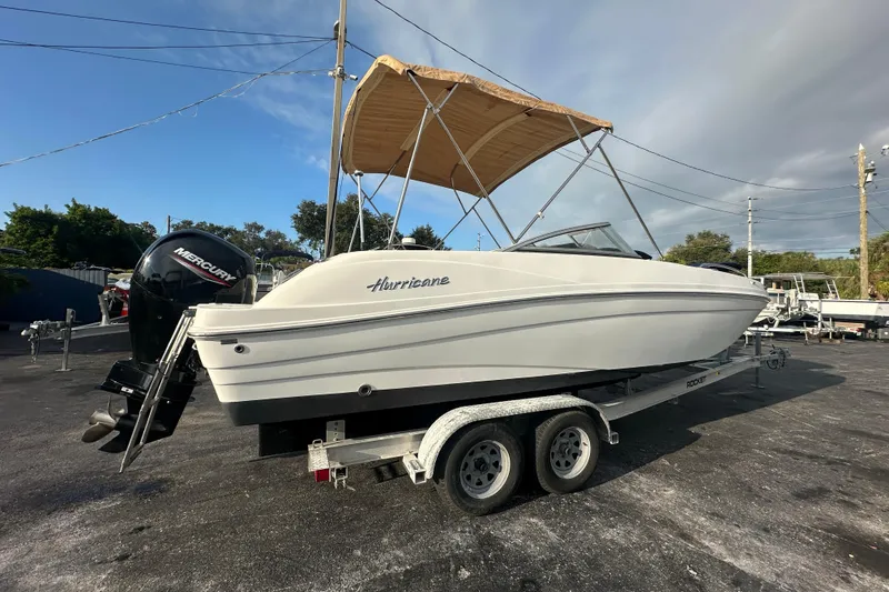 Slide: The Image of 2020 Hurricane SunDeck 217 OB boat on trailer with Mercury outboard motor. - 2