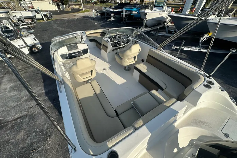 Slide: The Image of 2020 Hurricane SunDeck 217 OB boat interior with spacious seating and steering console. - 9