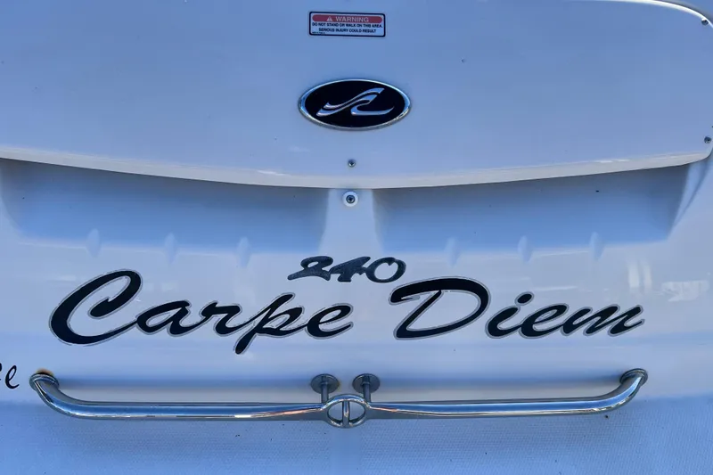 Slide: The Image of 2006 Sea Ray 240 Sundeck boat with "Carpe Diem" name on the stern. - 10