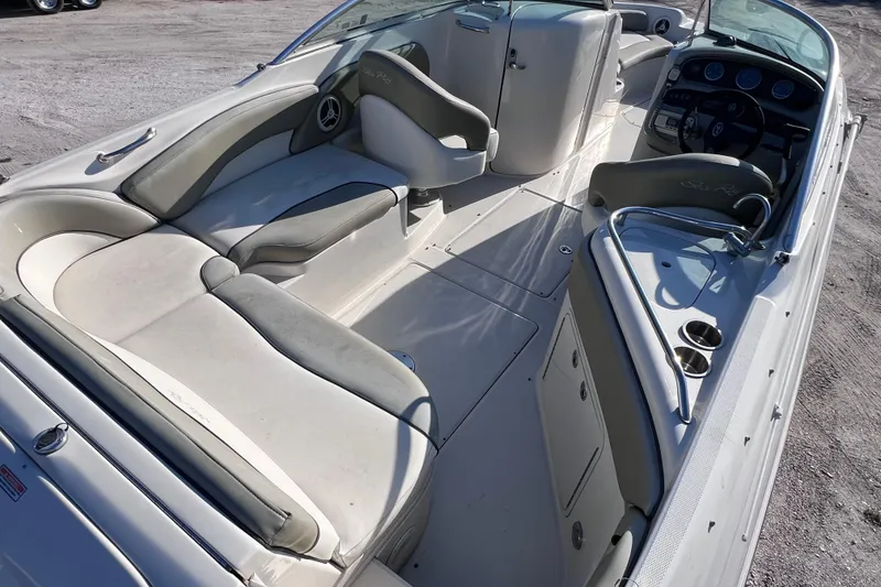 Slide: The Image of 2006 Sea Ray 240 Sundeck interior with spacious seating and modern dashboard. - 13