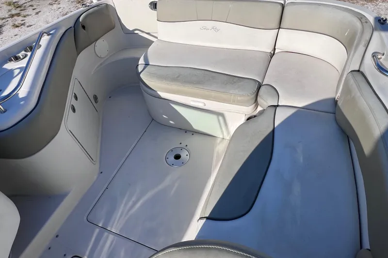 Slide: The Image of 2006 Sea Ray 240 Sundeck interior with cushioned seating and storage compartments. - 14