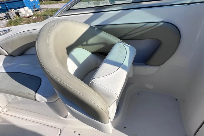 Slide: The Image of 2006 Sea Ray 240 Sundeck boat interior with beige seating and sleek design. - 17