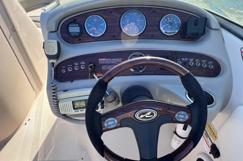 Slide: The Image of Steering console of a 2006 Sea Ray 240 Sundeck boat with gauges and controls. - 20