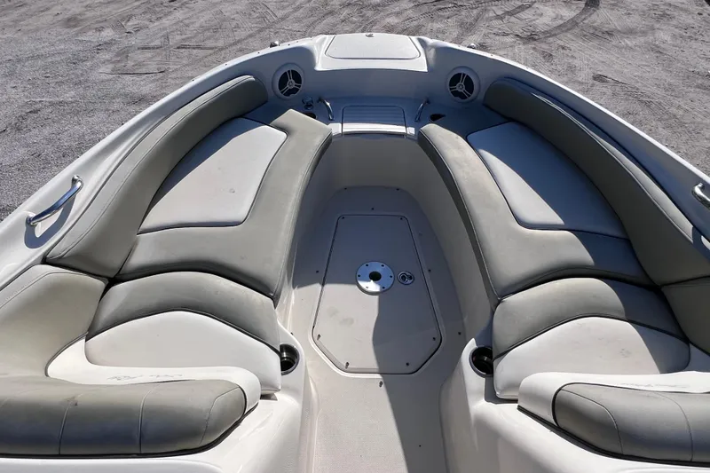Slide: The Image of 2006 Sea Ray 240 Sundeck boat interior with cushioned seating and speaker system. - 22