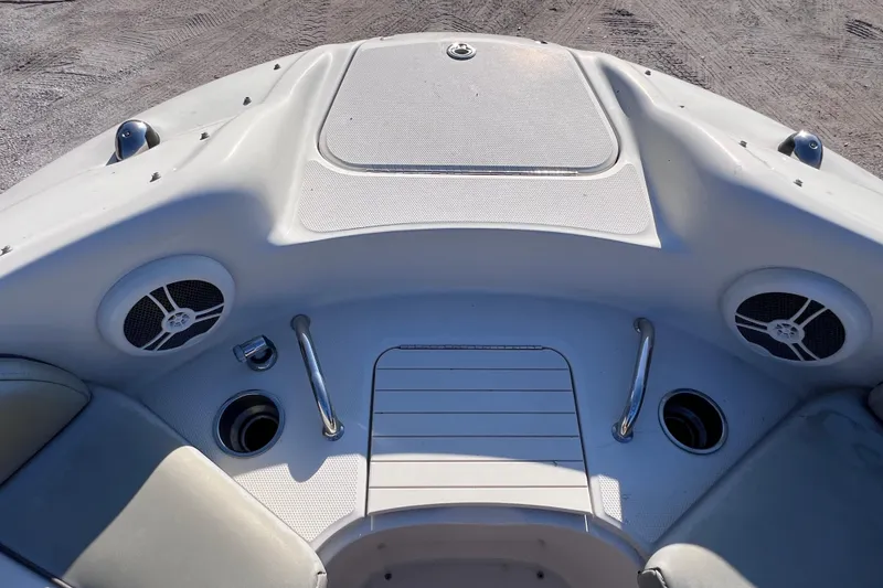 Slide: The Image of 2006 Sea Ray 240 Sundeck boat interior with speakers and seating area. - 23