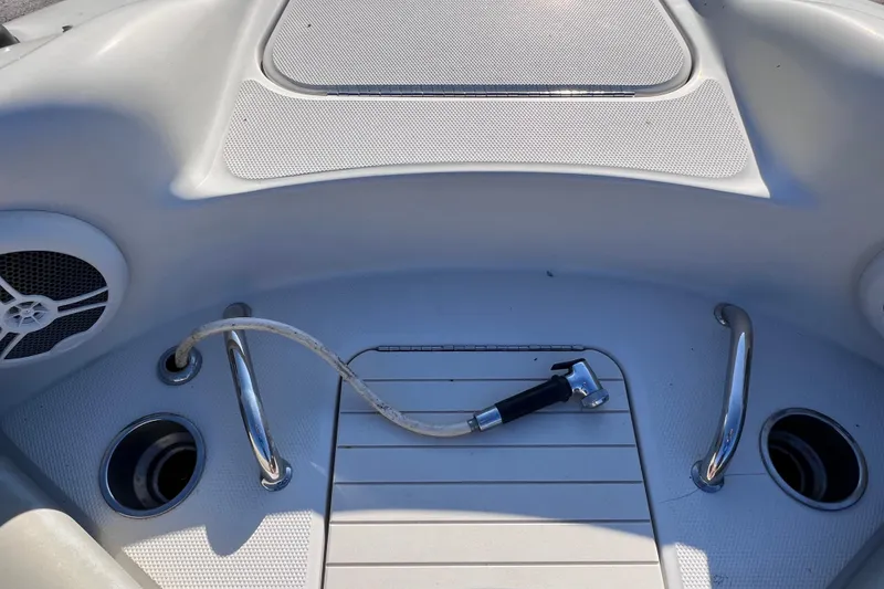 Slide: The Image of 2006 Sea Ray 240 Sundeck boat deck with hose and speaker. - 24