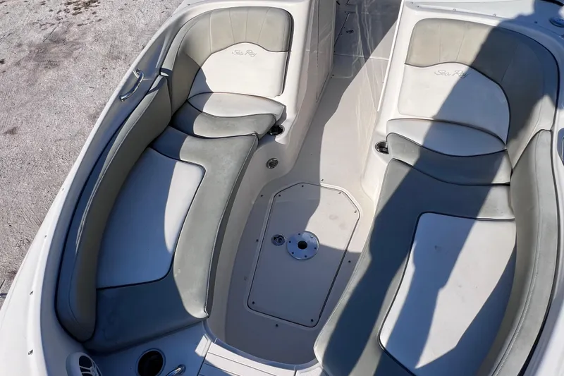 Slide: The Image of 2006 Sea Ray 240 Sundeck boat interior with cushioned seating and deck details. - 26
