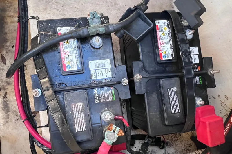 Slide: The Image of Batteries in a 2006 Sea Ray 240 Sundeck boat, showing wiring and connections. - 29