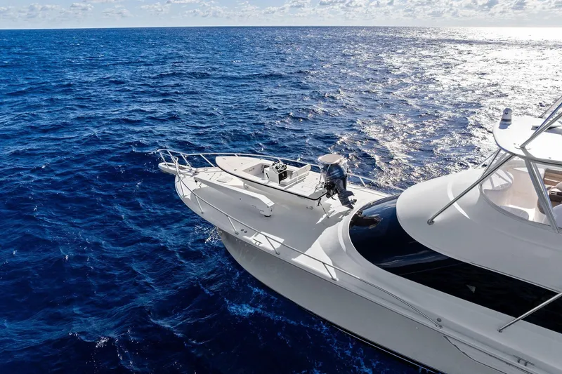 Slide: The Image of 2015 Viking 66' Convertible yacht cruising on open ocean waters. - 10
