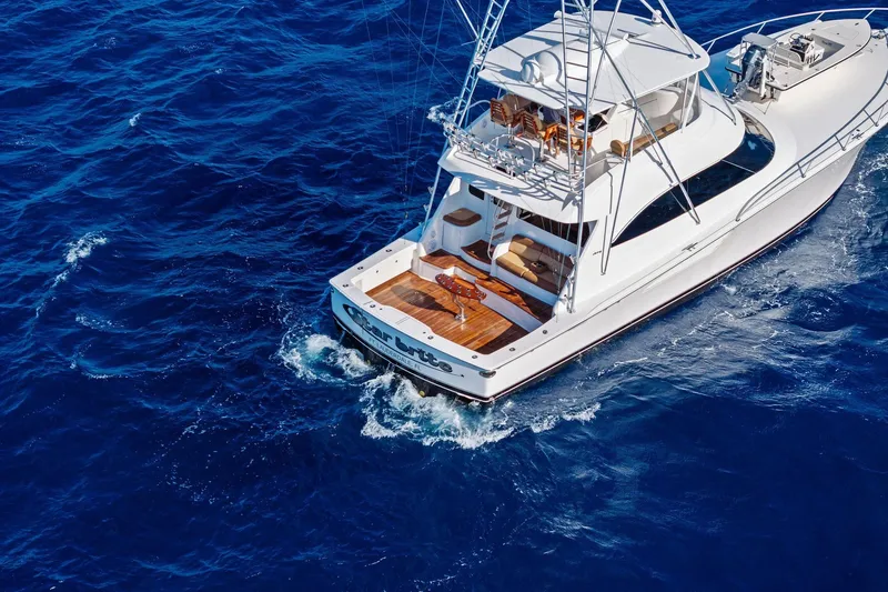 Slide: The Image of 2015 Viking 66' Convertible yacht cruising on deep blue ocean waters. - 11