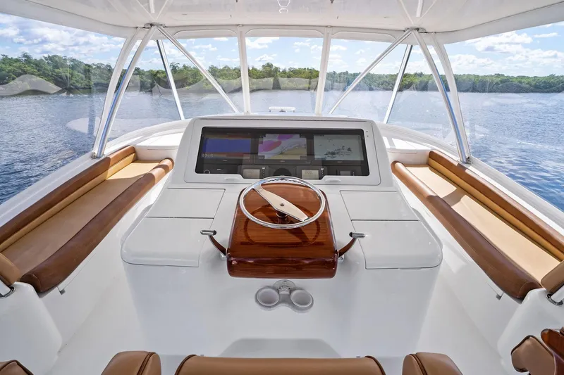 Slide: The Image of Cockpit of 2015 Viking 66' Convertible yacht with modern navigation system and leather seating. - 15