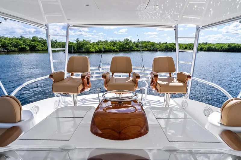 Slide: The Image of Luxurious 2015 Viking 66' Convertible yacht interior with plush seating and scenic water view. - 21