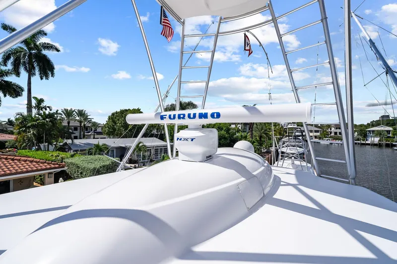 Slide: The Image of 2015 Viking 66' Convertible yacht with Furuno radar, docked near palm trees. - 23