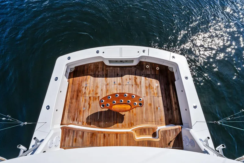 Slide: The Image of Aerial view of 2015 Viking 66' Convertible yacht's wooden deck on water. - 26