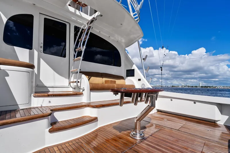 Slide: The Image of Luxurious 2015 Viking 66' Convertible yacht deck with wooden flooring and seating. - 28