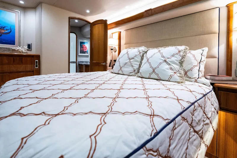 Slide: The Image of Luxurious bedroom interior of 2015 Viking 66' Convertible yacht with elegant bedding. - 39