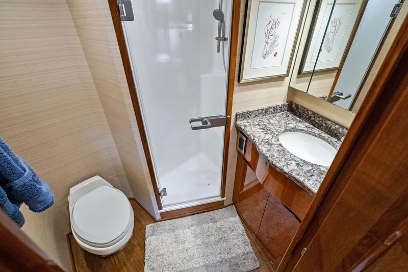 Slide: The Image of Luxurious bathroom in 2015 Viking 66' Convertible yacht with marble countertop and shower. - 41