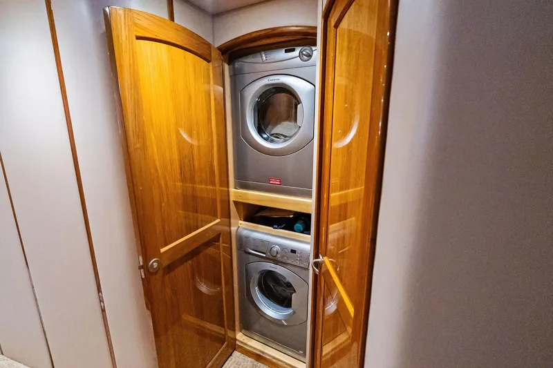 Slide: The Image of Laundry area with stacked washer and dryer in 2015 Viking 66' Convertible yacht. - 44