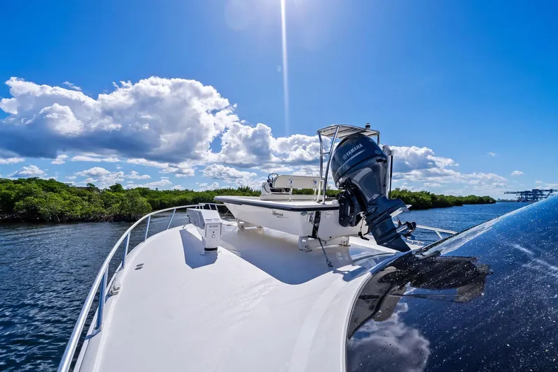 Slide: The Image of 2015 Viking 66' Convertible yacht cruising under a bright blue sky. - 45