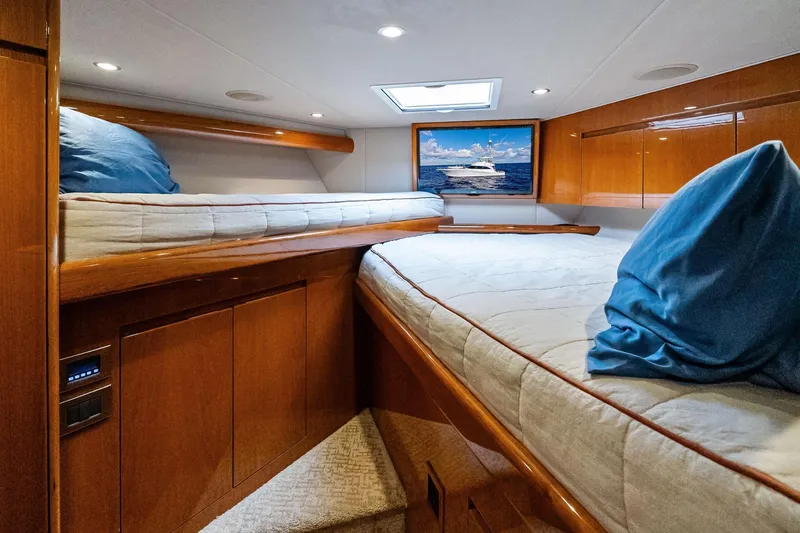 Slide: The Image of Luxurious cabin interior of 2015 Viking 66' Convertible yacht with wooden finishes. - 46