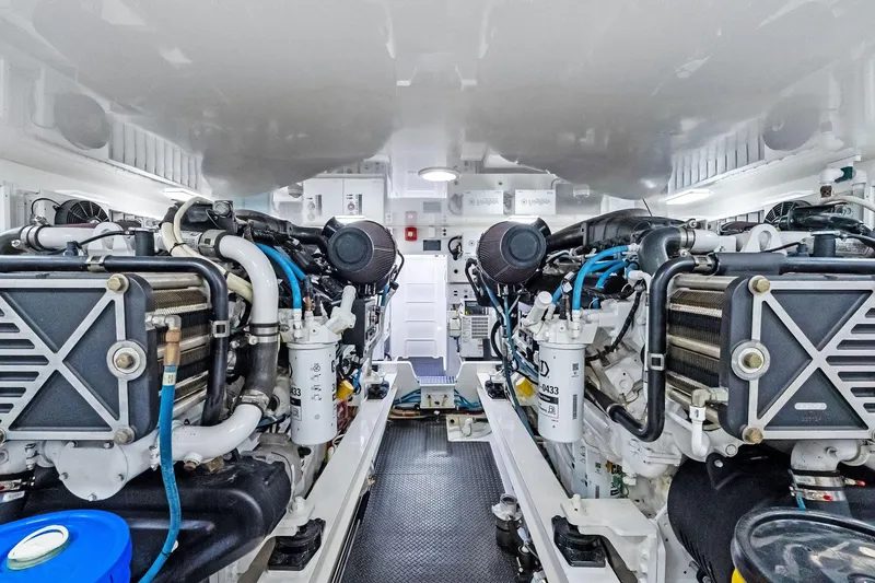 Slide: The Image of Engine room of 2015 Viking 66' Convertible yacht, showcasing dual engines and mechanical systems. - 54