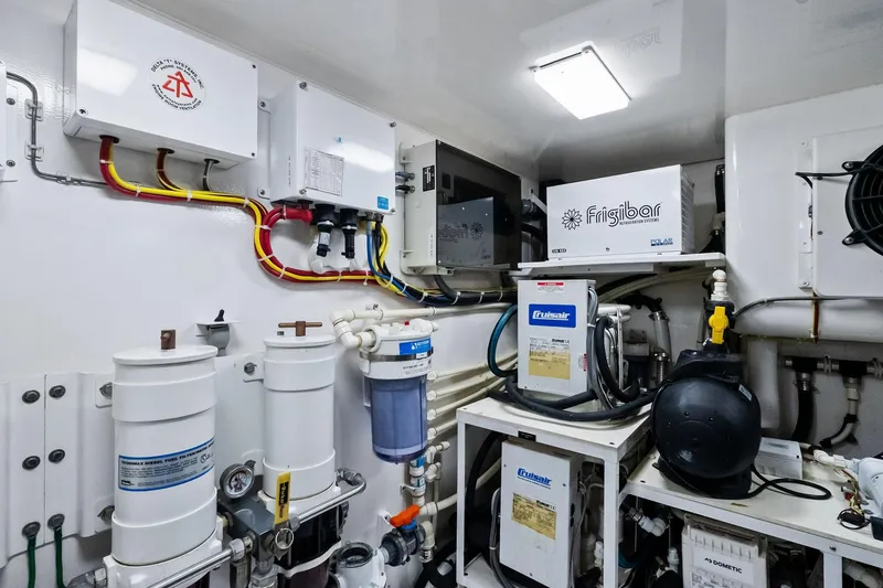 Slide: The Image of Engine room of 2015 Viking 66' Convertible yacht with various mechanical systems. - 55