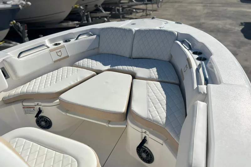 Slide: The Image of 2026 Sea Fox 228 Commander boat interior with cushioned seating and cup holders. - 10