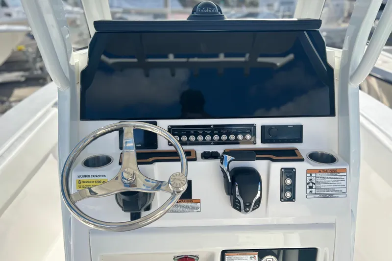 Slide: The Image of 2026 Sea Fox 228 Commander boat dashboard with steering wheel and controls. - 19