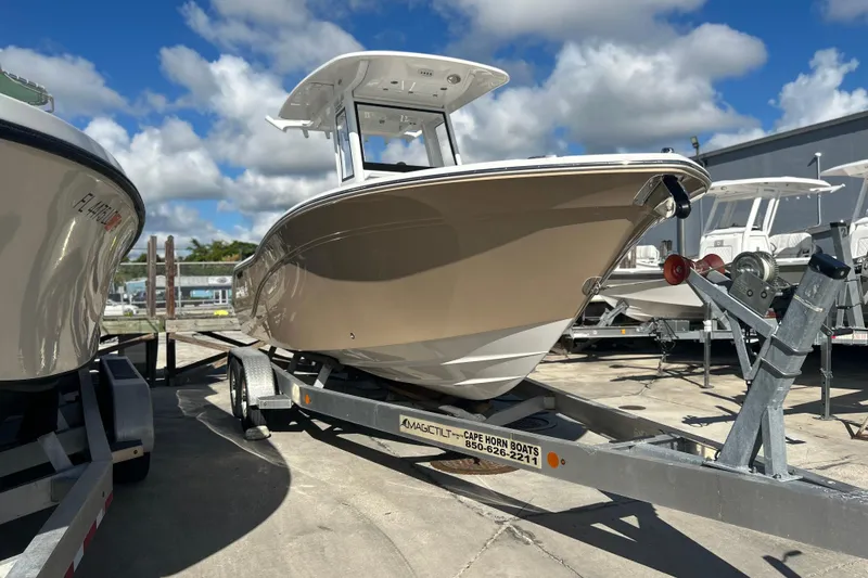 Slide: The Image of 2026 Sea Fox 228 Commander boat on trailer under blue sky. - 2