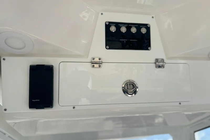 Slide: The Image of 2026 Sea Fox 228 Commander dashboard with control panel and storage compartment. - 24