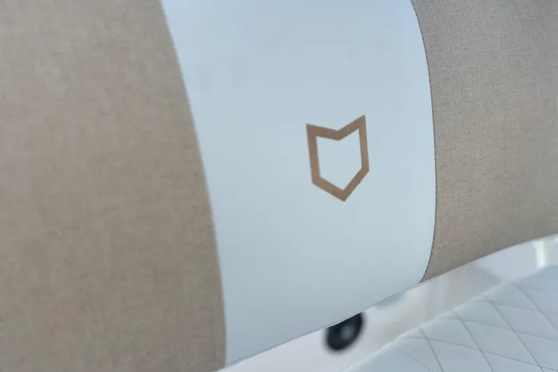 Slide: The Image of 2026 Sea Fox 228 Commander seat detail with logo, featuring beige and white upholstery. - 31