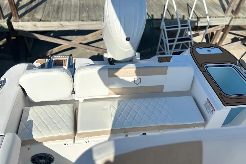 Slide: The Image of 2026 Sea Fox 228 Commander boat interior with cushioned seating and storage compartments. - 32