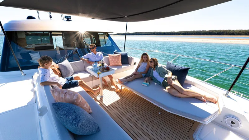 Slide: The Image of Family relaxing on the deck of a 2024 Riviera 585 SUV yacht. - 10